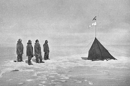 Roald Amundsen and his crew looking at the Norwegian flag at the South Pole, 1911