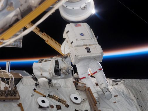 Spacewalking astronauts add solar arrays to the space station.
