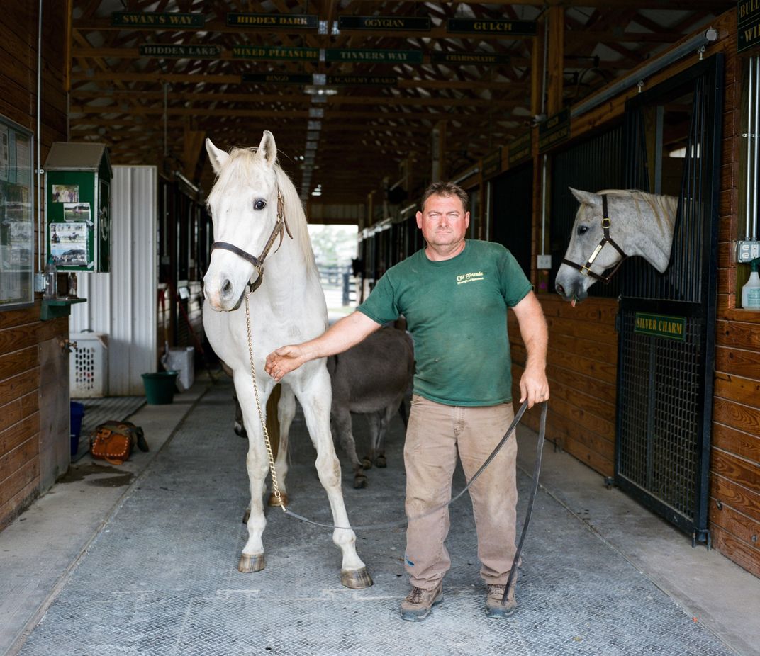 Farm manager James Crump with Alphabet Soup at Old Friends farm