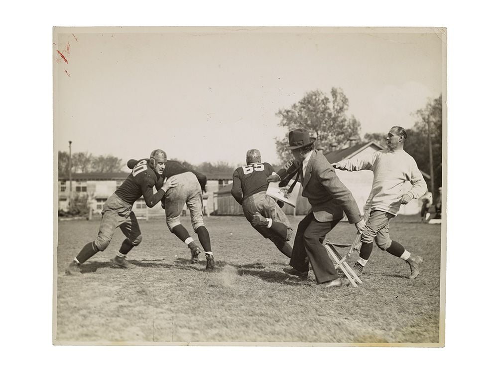 Photograph of John Steuart Curry sketching a football practice at the University of Wisconsin-Madison, 1936 or 1937 / unidentified photographer. John Steuart Curry and Curry family papers, 1848-1999. Archives of American Art, Smithsonian Institution.