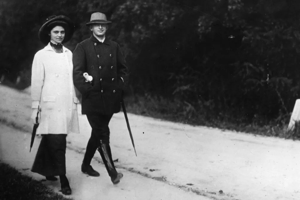 Black and white photo of a woman and man walking together
