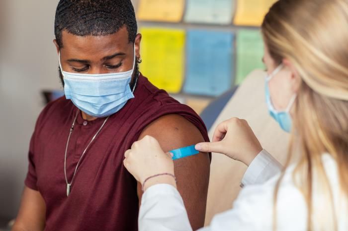 Doctor putting a bandage on patient's arm