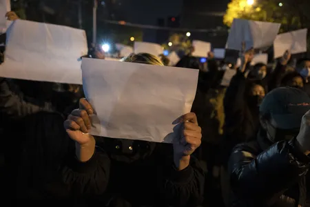 Protesters in Beijing hold up white sheets of paper during a November 27 protest against China&#39;s strict zero-Covid policy.
