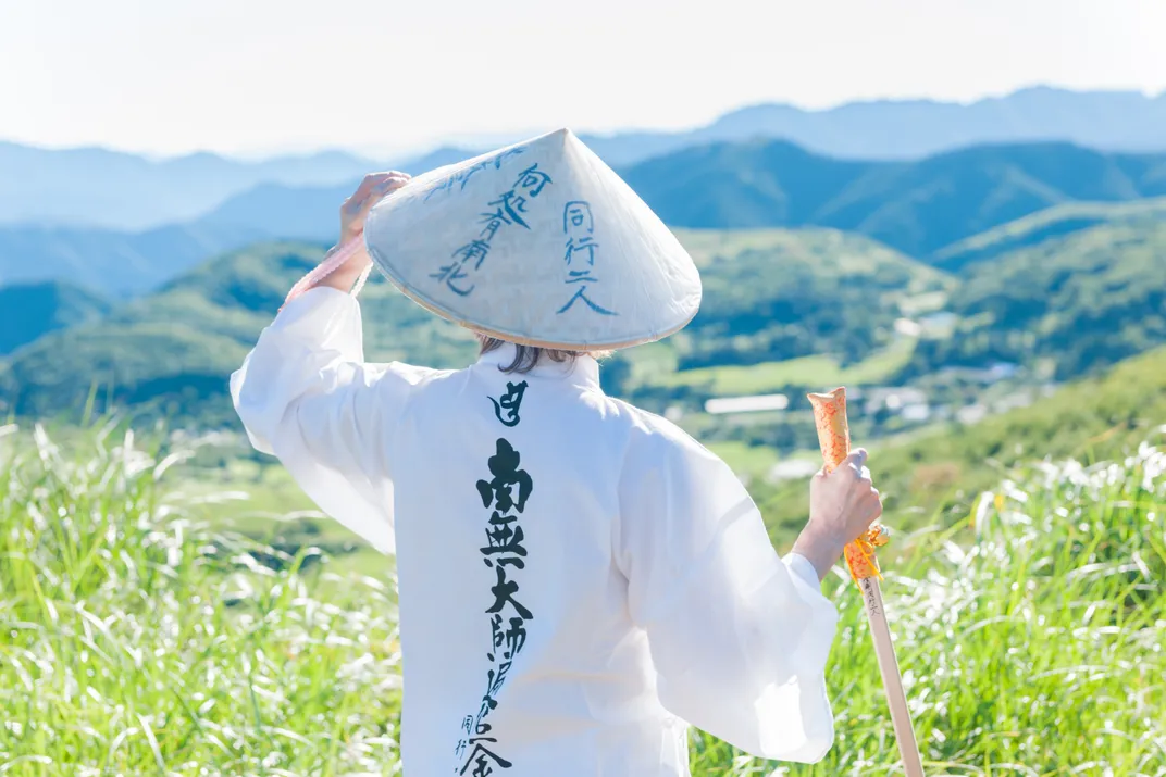 Pilgrim in traditional dress along the Shikoku Pilgrimage Trail