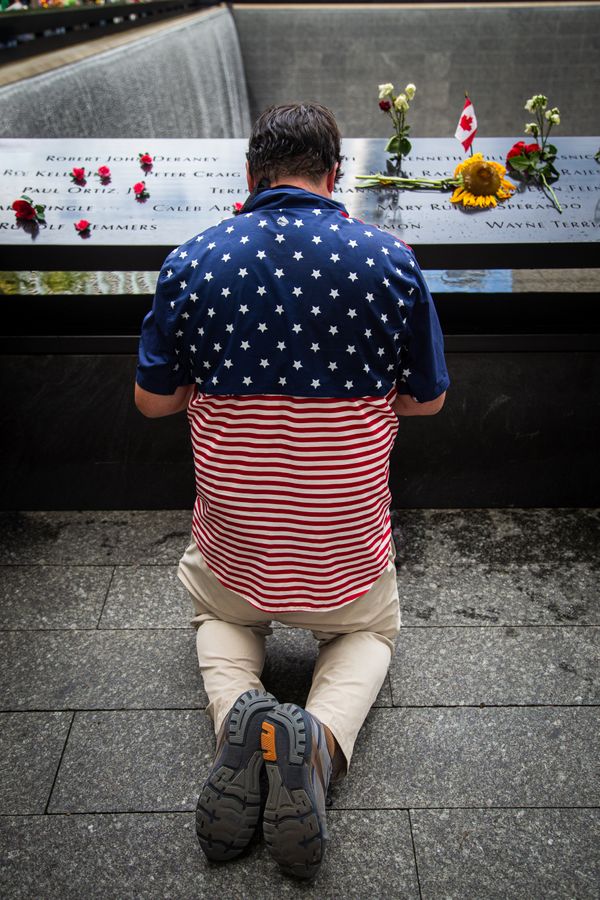 A Man Says a Prayer at the 9/11 Memorial thumbnail
