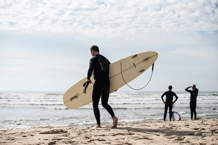 Surfers take to the water in Montauk, where a shark nursery was discovered offshore last summer.