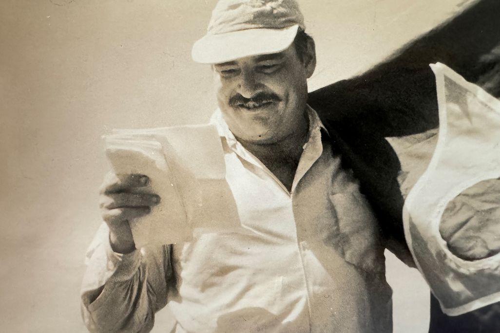 Leicester Hemingway reading a piece of paper