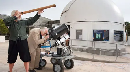 Galileo impersonator Mike Francis and curator David DeVorkin look at the skies through their respective telescopes.