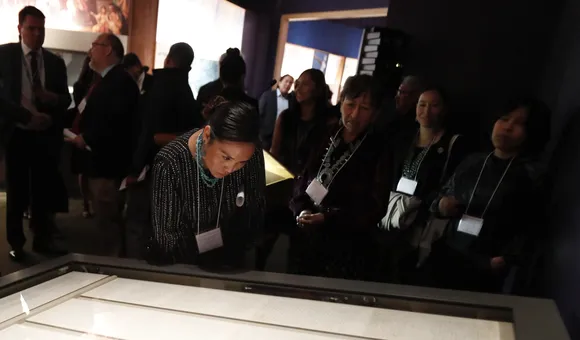 Representatives of the Navajo Nation read the original text of the Naaltsoos Sání, or Navajo Treaty of 1868, after its unveiling in the exhibition 