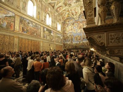 Tourists crowd the Sistine Chapel