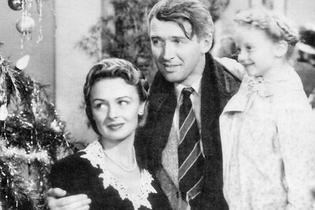 'It's a Wonderful Life' protagonist George Bailey with his family, Mary Hatch Bailey and Little Mary Hatch, at the end of the film.