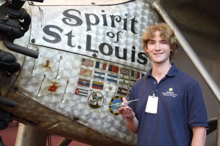 Museum specialist Chris Reddersen, holding a Spirit of St. Louis model that he and his dad built while Reddersen was in elementary school, got to work on the real thing as a volunteer at the National Air and Space Museum.