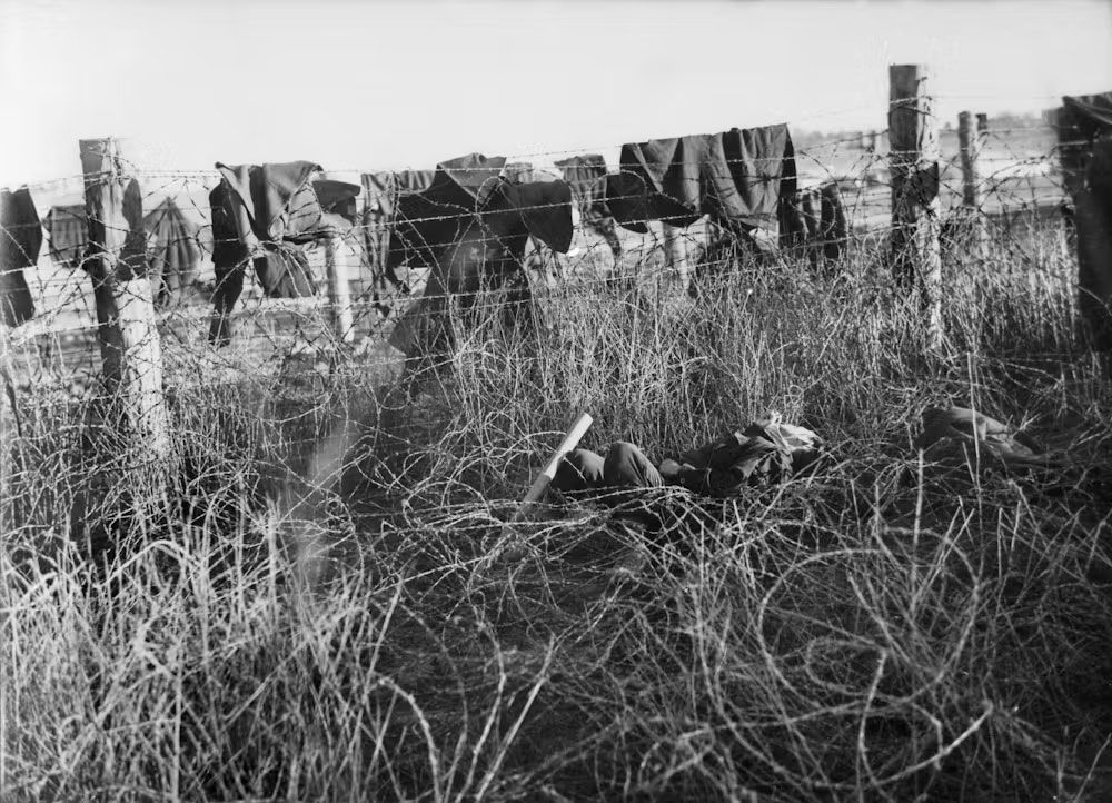 Clothing and blankets used as protection against the barbed wire