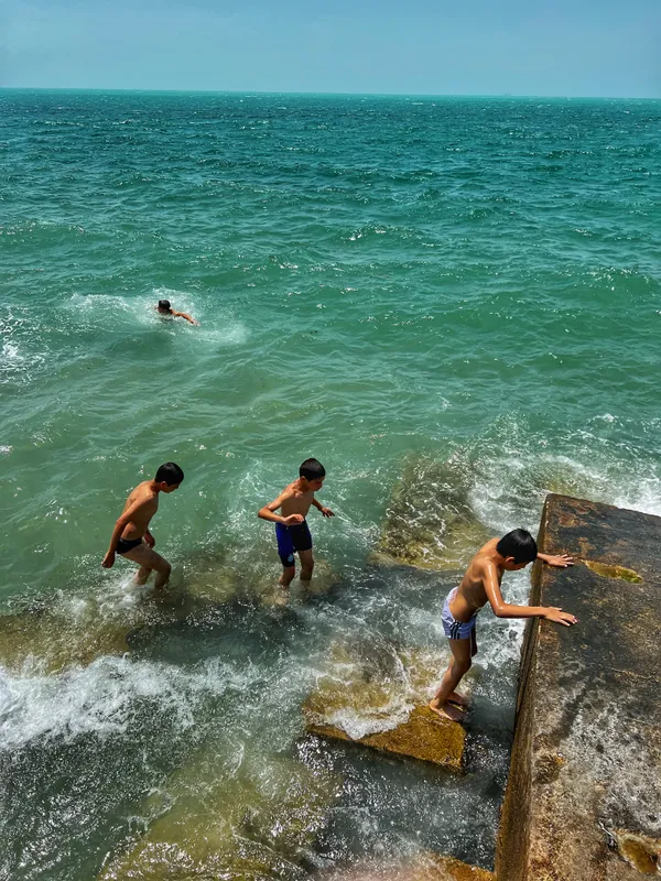 Children swimming in the warm southern sea under the blazing summer sun of Iran. thumbnail