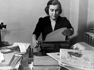 Virginia Irwin, in St. Louis in 1939. The Post-Dispatch on the desk next to her typewriter is the edition of Oct. 17, 1939, reporting the German sinking of the British Battleship Royal Oak at Scapa Flow, Scotland.