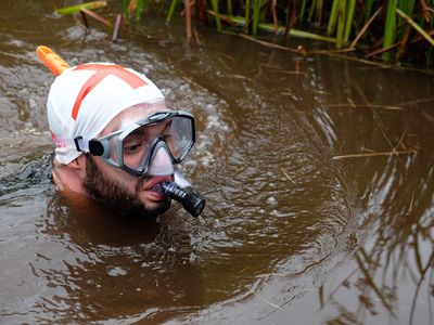 A competitor named Rich Welsh midway through his challenge at this year's World Bog Snorkeling Championships in Wales.