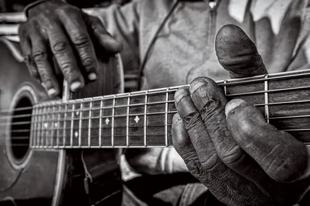 The worn hands and nubby fingernails of Bentonia, Mississippi, bluesman Jimmy "Duck" Holmes reflect his years of experience. Holmes is one of the last bluesmen who play a style known as Bentonia blues.