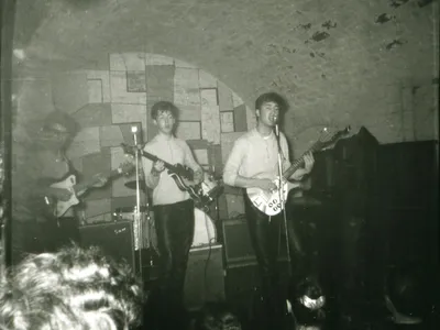 The Beatles&rsquo; George Harrison, Paul McCartney, John Lennon and original drummer Pete Best play a gig at the Cavern Club in Liverpool.