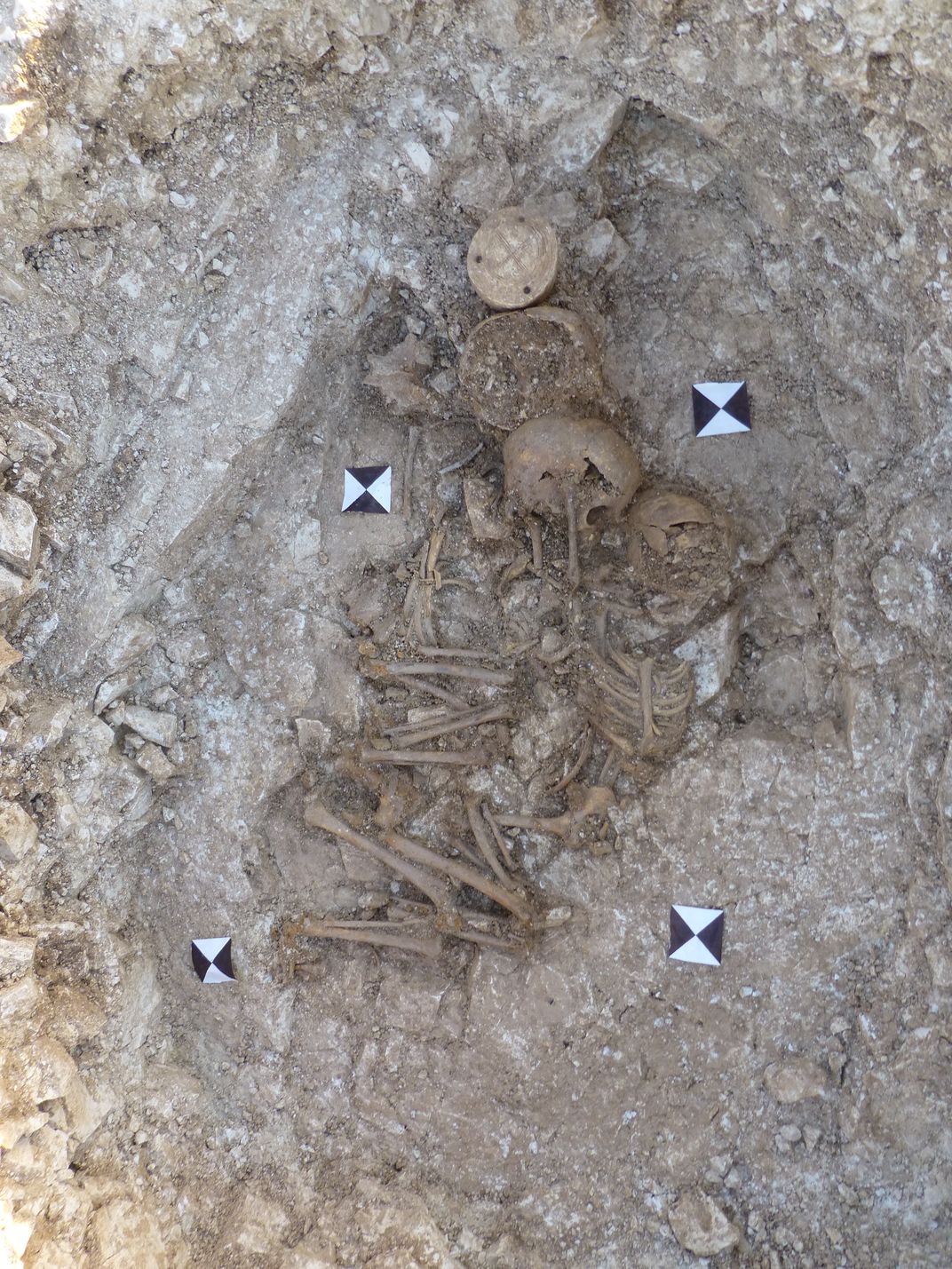 skeletal remains of children embracing each other