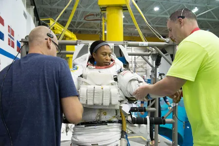 Jeanette Epps tries on a space suit