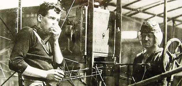 Just months after Lieutenant Paul Beck made an early airborne radio transmission, aviators test a receiving set - with the airplane's engine running - on North Island, Washington.