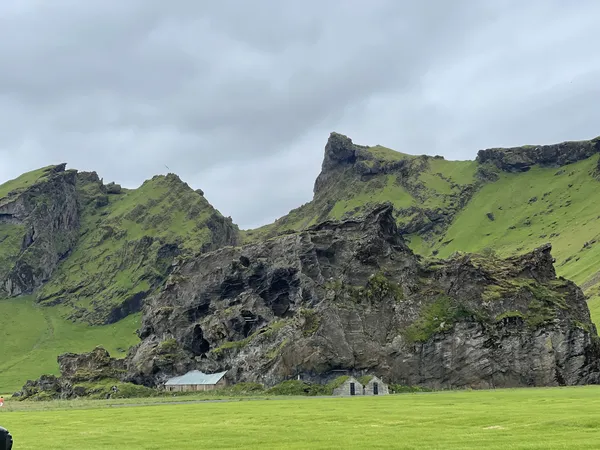 Dwellings under a big rock in Iceland thumbnail