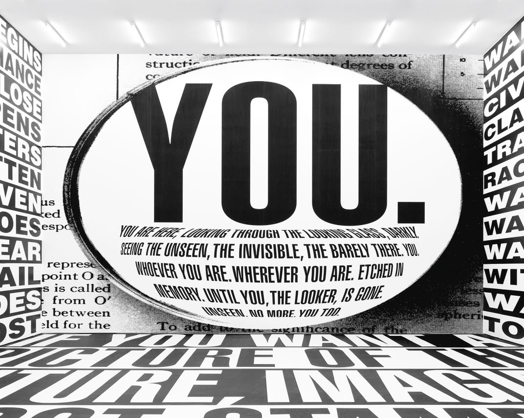 A view of Kruger's installation of black-and-white text covering the floors and ceiling, with an enormous YOU. taking center stage