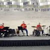 Four U.S. Marine band members perform on stage inside the museum
