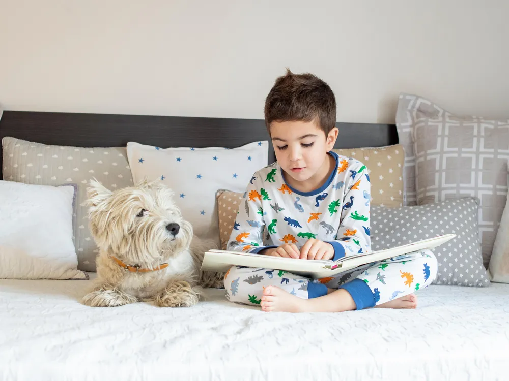 Boy reading with his dog