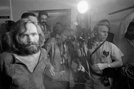 Cameramen film the scene as Charles Manson is brought into the Los Angeles city jail under suspicion of having masterminded the Tate-LaBianca murders of August 1969.