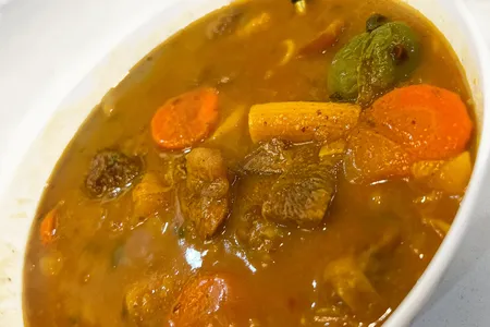 Soup joumou is a savory, orange-tinted soup that typically consists of calabaza squash, beef, noodles, carrots, cabbage, various other vegetables and fresh herbs and spices.