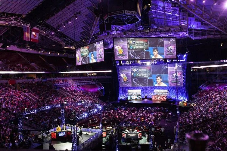 An arena packed with people watching others play video games.