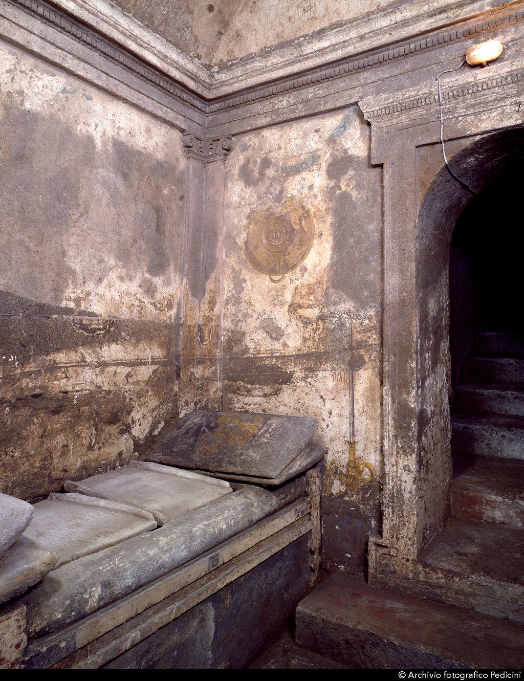 Rock-cut "bed" and "pillows" in the Naples tomb