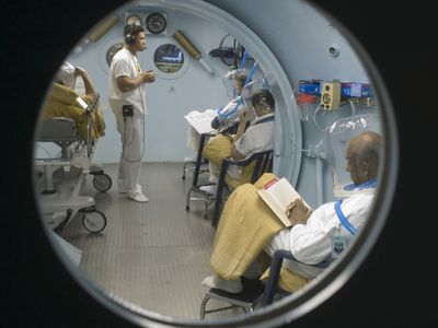 SSgt Jalkenne Joseph, Aerospace Medical Craftsman from the 959th MSGS, Wilford Hall, monitors patients in the USAFSAM Clinical Hyperbaric Medicine, hyperbaric pressure chamber. By spending time in the chamber patients are exposed to excessive amounts of oxygen which enriches the blood to the point where oxygen is even carried by plasma, which increases the body�s ability to heal. (US Air Force photo by Steve Thurow)