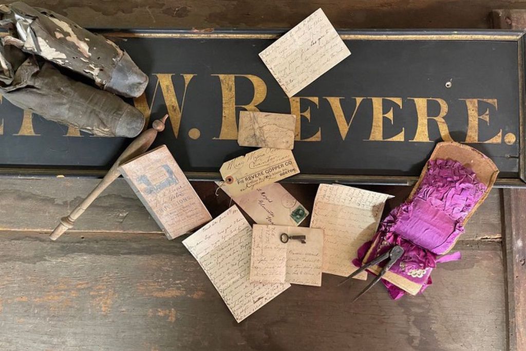 Letters and documents on top of the trade sign bearing the name Joseph W. Revere