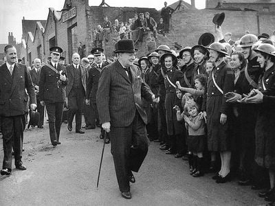 Winston Churchill visits bomb-damaged Birmingham, England, during the Blitz.