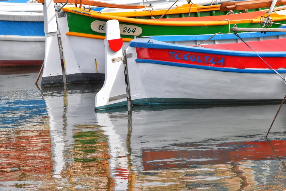 While touring from our ship, we bussed to Sanary, France to see its market. As I wandered through the market, I couldn’t help but notice the colorful boats in the harbor. I felt that these two boats and their reflection made for an interesting composition so I used my zoom lens to capture the shot.