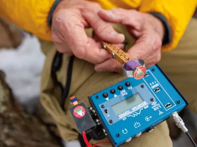Steve Galchutt shows off the custom-made low-wattage transmitter he uses on his treks.