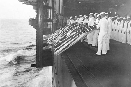 Nov. 26, 1944: Burial at sea ceremonies are held aboard the USS Intrepid for members of the crew lost after the carrier was hit by a Japanese suicide pilot while operating off the coast of Luzon, the Philippines, during World War II. Sixteen men were killed in the kamikaze attack. (AP Photo/U.S. Navy)