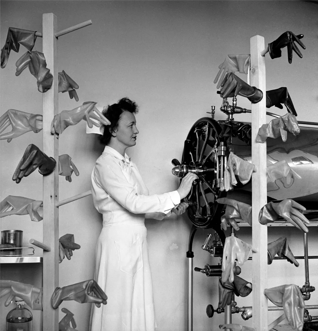 A U.S. Army nurse drying sterilized rubber gloves at the Churchill Hospital in Oxford, England, in 1943