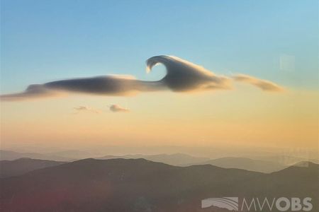 Not one, but two rare cloud features hovered side by side, lit by the sunrise, on Monday morning over Mount Washington in New Hampshire.