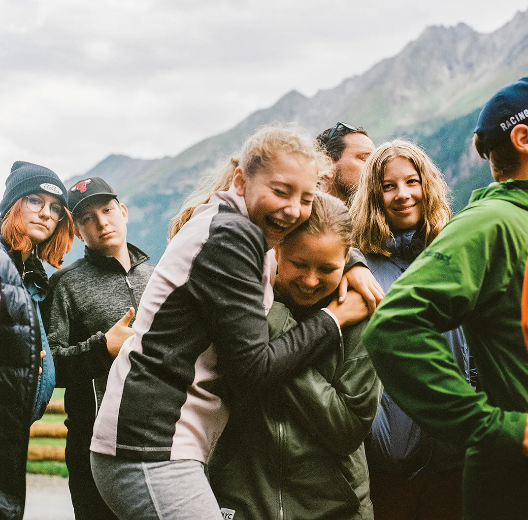 Members of a choir from Salzburg gather outside the Krimmler Tauernhaus after performing for trekkers who took part in the peace crossing.