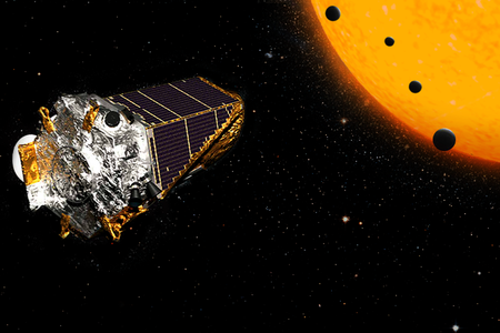 An artist's conception of four of the new planets, orbiting a single dwarf star. These small, rocky worlds are far closer to their star than Mercury is to our sun, but the star is smaller and cooler than our own.
