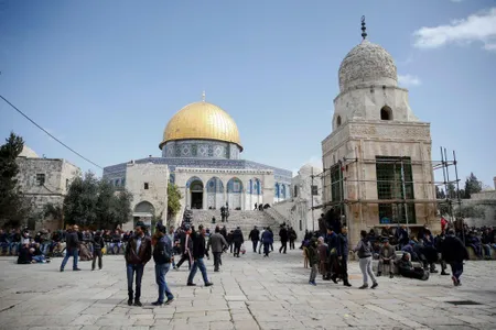Palestinians gather to perform the Friday prayer at the Al-Aqsa Mosque Compound in Jerusalem
