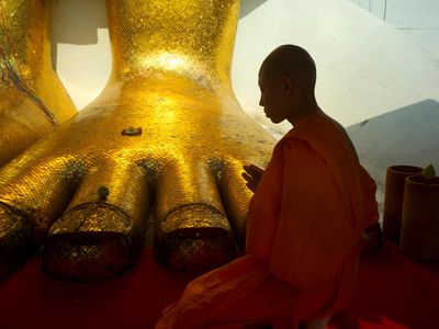 A Buddhist monk prays in a temple. Scientists recently discovered the mummified body of a Buddhist monk some say is in a long-term trance. 