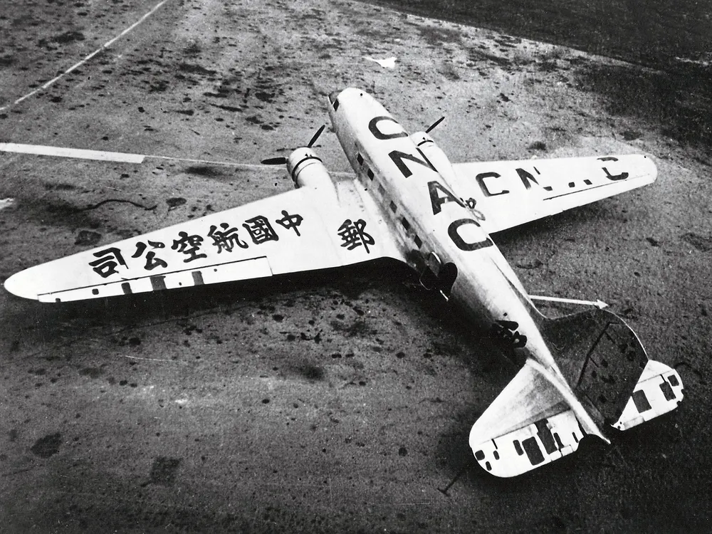 airplane with mismatched wings with Japanese characters on the wing and Roman letters on the body