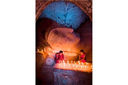 GRAND PRIZE WINNER
Young monks from Myanmar
Bagan, Myanmar &bull; Photographed April 2007
Winn traveled north from his home in Yangon to the countryside of old Bagan to capture this image of young Buddhist monks in the Shwesandaw Temple. “I found them lighting candles and praying,” Winn says. “You can see monks everywhere in Myanmar.” 
