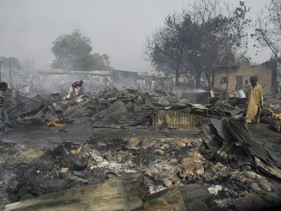 Nigerian boys sift through the remains of the Gamboru market after multiple explosions took place Maiduguri, northern Nigeria, on February 7, 2012. Boko Haram claimed responsibility for the attacks. 