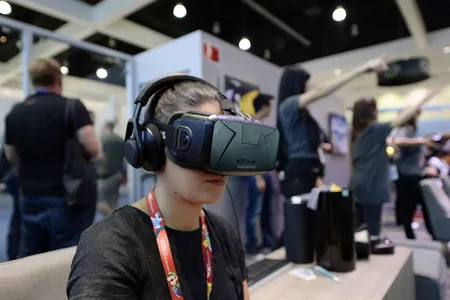 An attendee at the 2014 Electronic Entertainment Expo,  in Los Angeles, California, tries out an Oculus VR headset kit.