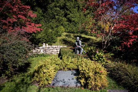 A sculpture depicting Irish author James Joyce is seen behind his grave in Fluntern cemetery in Zurich